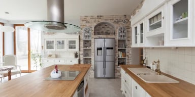 Modern kitchen with white cabinets and stainless steel appliances
